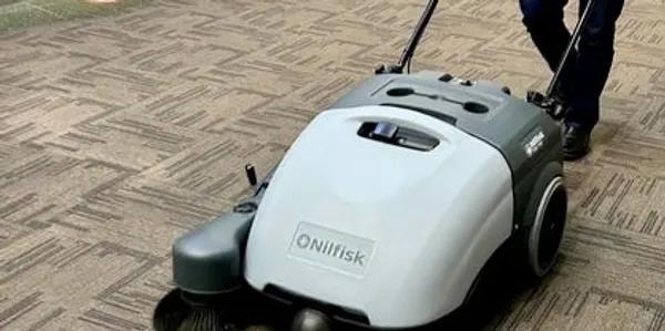 Nilfisk carpet sweeper machine in use